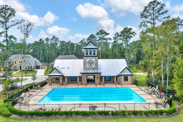 510 Blossom Cove Ct, Pinehurst, TX 77362 - community pool featuring fence and a patio area