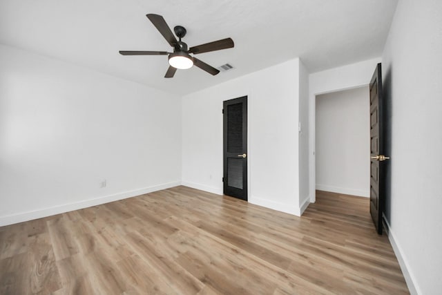 5638 N Braeswood Blvd, Houston, TX 77096 - unfurnished bedroom with light wood-style floors, a ceiling fan, and baseboards