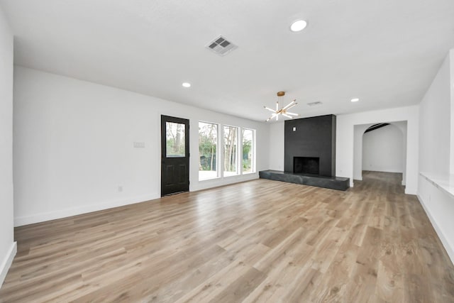 5638 N Braeswood Blvd, Houston, TX 77096 - unfurnished living room featuring light wood finished floors, a chandelier, baseboards, recessed lighting, and a fireplace