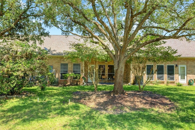 734 E Country Grove Cir, Pearland, TX 77584 - back of house with brick siding, roof with shingles, and a yard