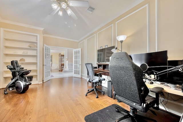 4106 Alice Dr, Sugar Land, TX 77478 - office with french doors, a decorative wall, a ceiling fan, built in shelves, and wood finished floors