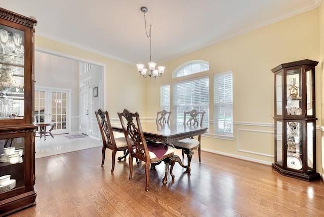 4106 Alice Dr, Sugar Land, TX 77478 - dining space with wood finished floors, crown molding, a chandelier, and french doors