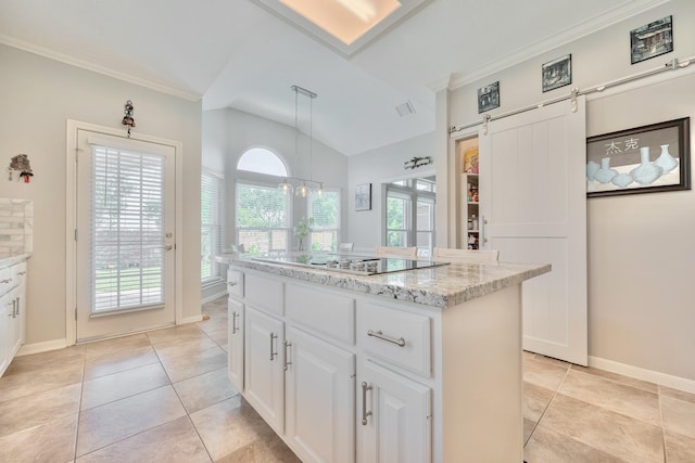 4106 Alice Dr, Sugar Land, TX 77478 - kitchen with black electric stovetop, lofted ceiling, white cabinetry, ornamental molding, and a center island
