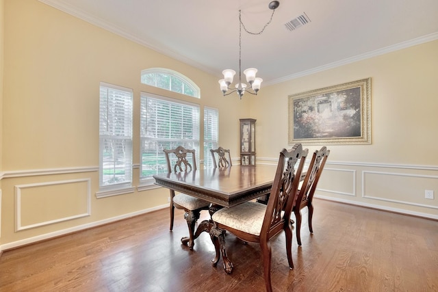 4106 Alice Dr, Sugar Land, TX 77478 - dining space with a chandelier, ornamental molding, wood finished floors, and baseboards