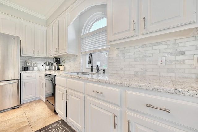 4106 Alice Dr, Sugar Land, TX 77478 - kitchen with freestanding refrigerator, black dishwasher, a sink, white cabinets, and backsplash