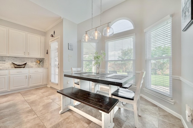 4106 Alice Dr, Sugar Land, TX 77478 - dining room featuring plenty of natural light, light tile patterned floors, baseboards, and ornamental molding