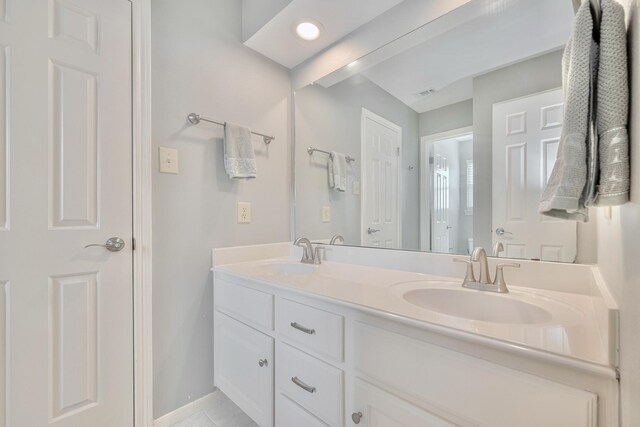 4106 Alice Dr, Sugar Land, TX 77478 - full bath with double vanity, baseboards, and tile patterned flooring