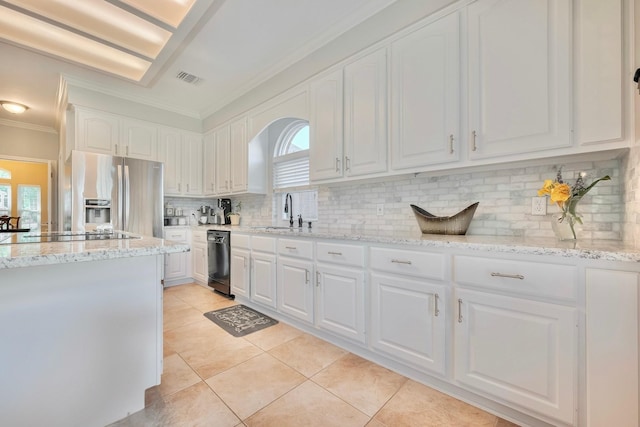4106 Alice Dr, Sugar Land, TX 77478 - kitchen with black appliances, a sink, crown molding, healthy amount of natural light, and white cabinetry