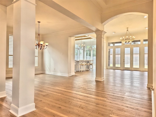 9923 Eden Valley Dr, Spring, TX 77379 - unfurnished dining area featuring a chandelier, ornamental molding, decorative columns, baseboards, and arched walkways