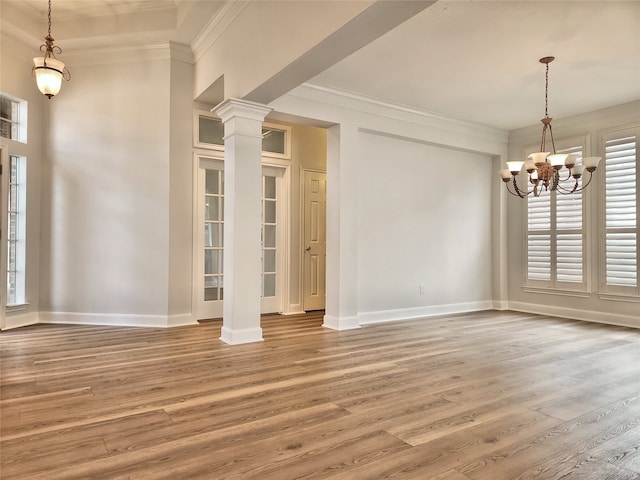 9923 Eden Valley Dr, Spring, TX 77379 - unfurnished dining area featuring plenty of natural light, a chandelier, wood finished floors, and crown molding