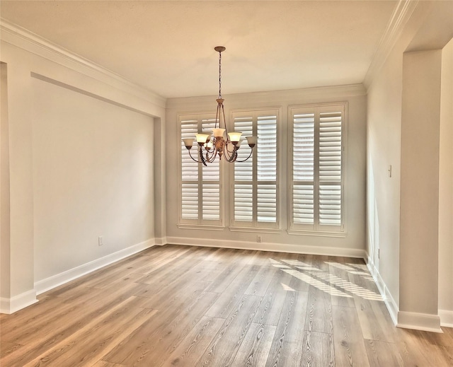 9923 Eden Valley Dr, Spring, TX 77379 - unfurnished dining area featuring ornamental molding, a chandelier, baseboards, and wood finished floors