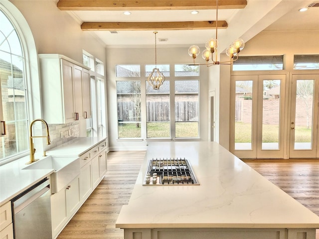 9923 Eden Valley Dr, Spring, TX 77379 - kitchen with appliances with stainless steel finishes, a chandelier, light wood-type flooring, a sink, and beam ceiling