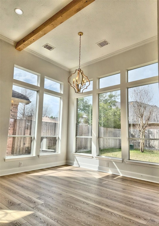 9923 Eden Valley Dr, Spring, TX 77379 - unfurnished dining area featuring ornamental molding, wood finished floors, a chandelier, beam ceiling, and baseboards