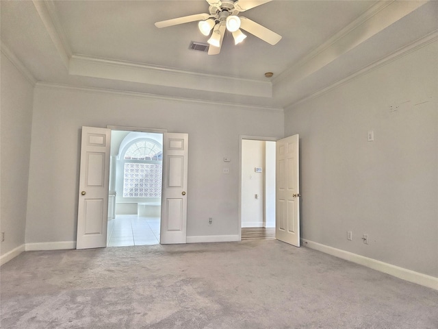 9923 Eden Valley Dr, Spring, TX 77379 - unfurnished bedroom with a tray ceiling, carpet floors, ornamental molding, baseboards, and a ceiling fan