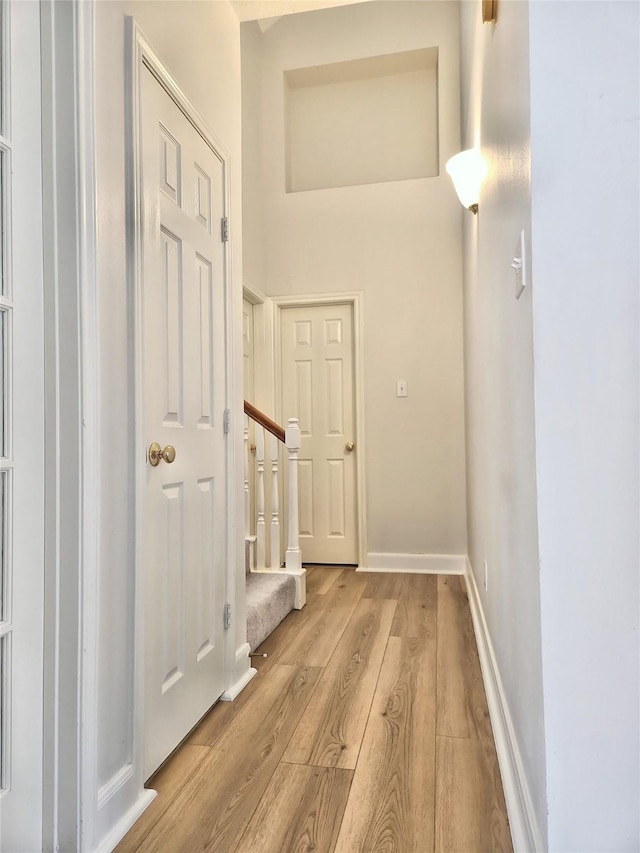 9923 Eden Valley Dr, Spring, TX 77379 - hall featuring light wood-style flooring, baseboards, and stairway