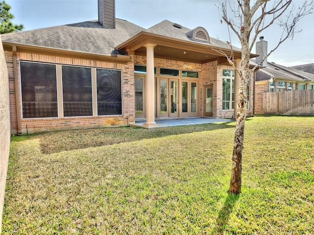 9923 Eden Valley Dr, Spring, TX 77379 - rear view of property featuring brick siding, a chimney, a patio area, and roof with shingles