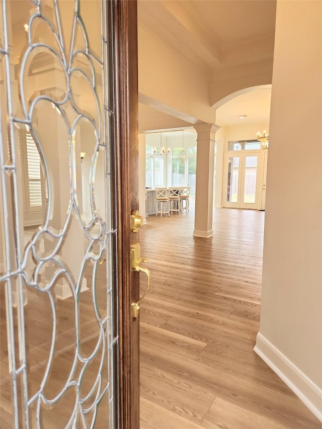 9923 Eden Valley Dr, Spring, TX 77379 - hall with ornamental molding, ornate columns, a chandelier, baseboards, and arched walkways