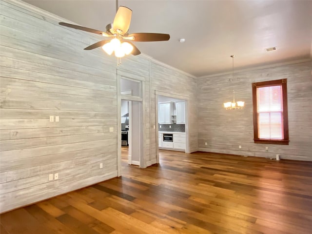 2012 Avenue N 1/2 Ave N 1/2, Galveston, TX 77550 - unfurnished living room featuring a chandelier, a ceiling fan, wood finished floors, and crown molding