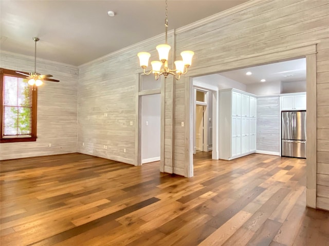 2012 Avenue N 1/2 Ave N 1/2, Galveston, TX 77550 - unfurnished dining area featuring a chandelier, wood finished floors, wood walls, a ceiling fan, and ornamental molding