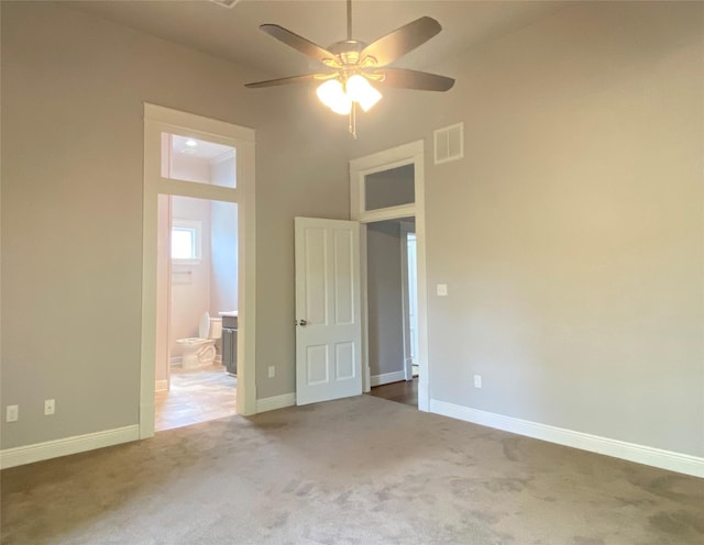 2012 Avenue N 1/2 Ave N 1/2, Galveston, TX 77550 - unfurnished bedroom featuring carpet floors, connected bathroom, and a ceiling fan