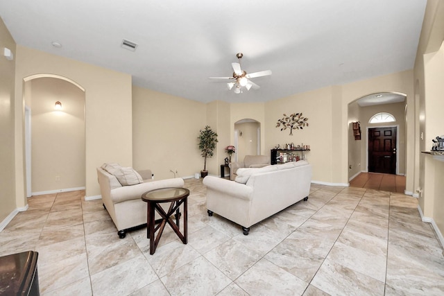3018 Wellington Pass Dr, Spring, TX 77373 - living room featuring arched walkways, a ceiling fan, and baseboards