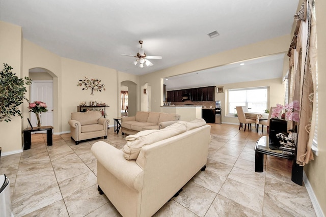 3018 Wellington Pass Dr, Spring, TX 77373 - living area featuring arched walkways, ceiling fan, and baseboards