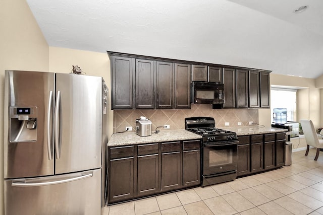 3018 Wellington Pass Dr, Spring, TX 77373 - kitchen featuring black appliances, light tile patterned flooring, dark brown cabinets, decorative backsplash, and light stone counters