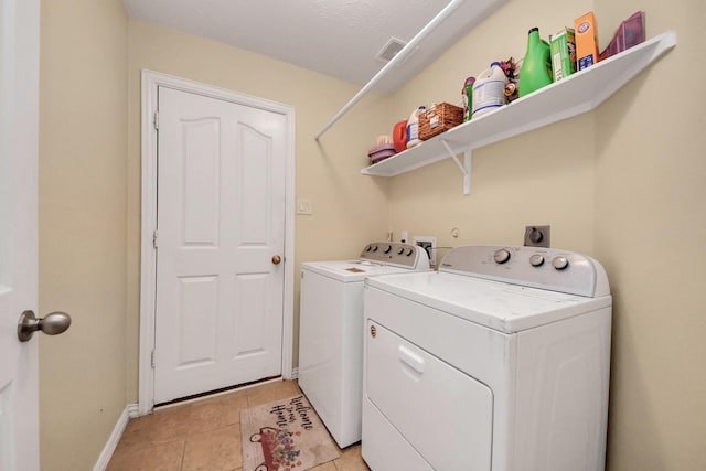 3018 Wellington Pass Dr, Spring, TX 77373 - washroom with washing machine and dryer, baseboards, and light tile patterned floors