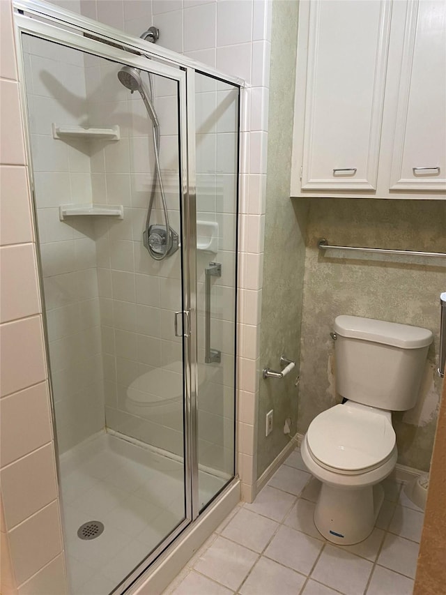 4315 Westheimer Rd, Houston, TX 77027 - bathroom with a shower stall, tile patterned floors, and toilet