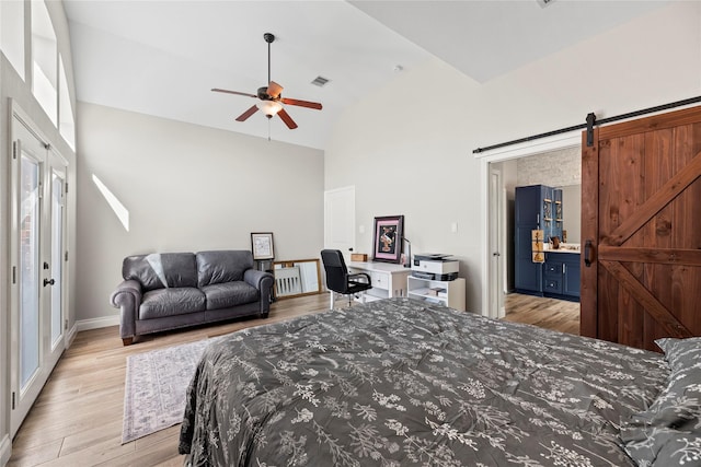 20123 Everhart Springs Ln, Cypress, TX 77433 - bedroom featuring a barn door, wood finished floors, high vaulted ceiling, baseboards, and ensuite bath
