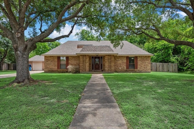 1520 Sycamore St, Navasota, TX 77868 - view of front of house with roof with shingles, brick siding, and a detached garage