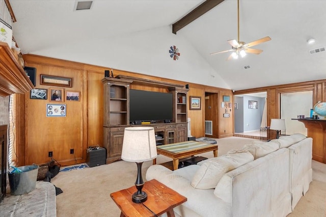 1520 Sycamore St, Navasota, TX 77868 - living area with high vaulted ceiling, light carpet, ceiling fan, beam ceiling, and wooden walls