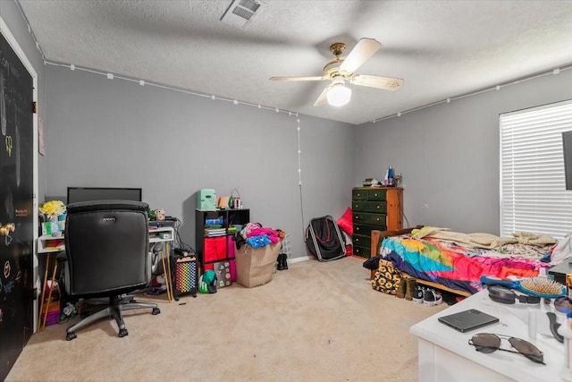 1520 Sycamore St, Navasota, TX 77868 - bedroom featuring carpet, a textured ceiling, an office area, and ceiling fan