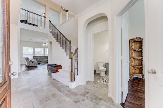 13203 Edison Trace Ln, Tomball, TX 77377 - foyer featuring stairway, ceiling fan, baseboards, and crown molding