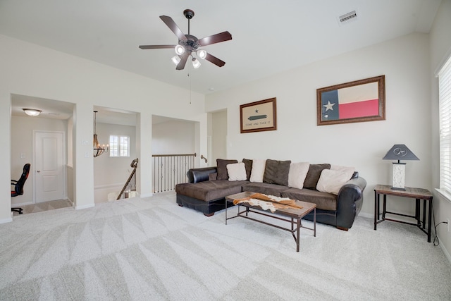 13203 Edison Trace Ln, Tomball, TX 77377 - carpeted living room featuring a ceiling fan, baseboards, and a chandelier