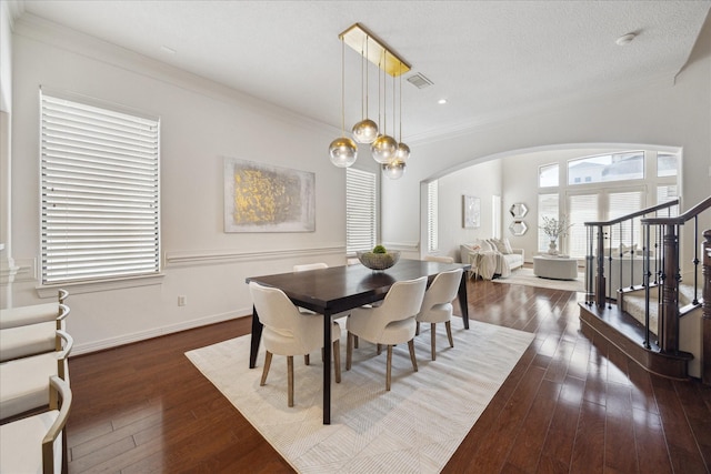 614 W Bell St Unit A, Houston, TX 77019 - dining room featuring arched walkways, wood-type flooring, stairway, baseboards, and crown molding