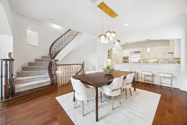 614 W Bell St Unit A, Houston, TX 77019 - dining area featuring dark wood-style floors, stairway, crown molding, arched walkways, and recessed lighting