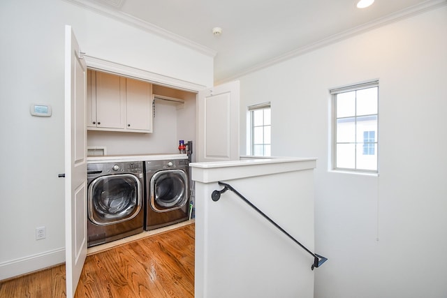 4006 Feagan St Unit D, Houston, TX 77007 - washroom with cabinet space, independent washer and dryer, crown molding, light wood-type flooring, and baseboards
