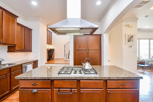 4006 Feagan St Unit D, Houston, TX 77007 - kitchen with island range hood, stainless steel appliances, arched walkways, a sink, and light wood finished floors