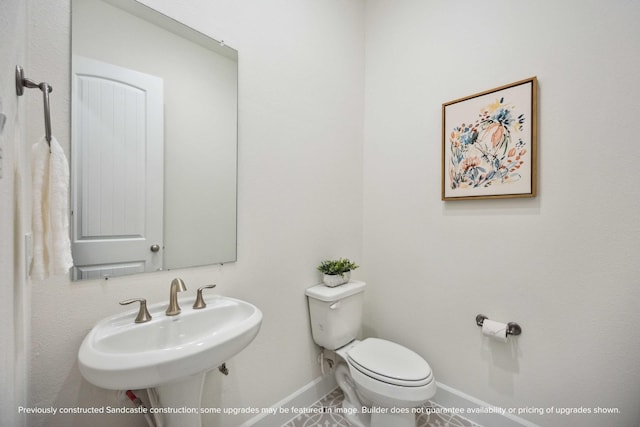 222 E 27th St, Houston, TX 77008 - half bathroom featuring toilet, baseboards, a sink, and tile patterned flooring