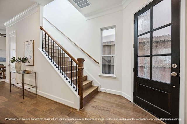 222 E 27th St, Houston, TX 77008 - foyer with crown molding, baseboards, wood finished floors, and stairs