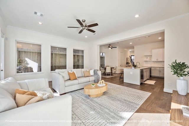 222 E 27th St, Houston, TX 77008 - living area with a ceiling fan, ornamental molding, dark wood finished floors, and recessed lighting