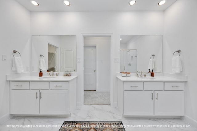 222 E 27th St, Houston, TX 77008 - bathroom featuring marble look tile flooring, recessed lighting, baseboards, a stall shower, and two vanities