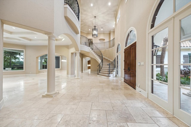 3110 Noble Lakes Ln, Houston, TX 77082 - foyer featuring ornate columns, stone tile floors, a high ceiling, baseboards, and arched walkways