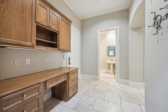 3110 Noble Lakes Ln, Houston, TX 77082 - unfurnished office with built in desk, crown molding, baseboards, and stone tile flooring