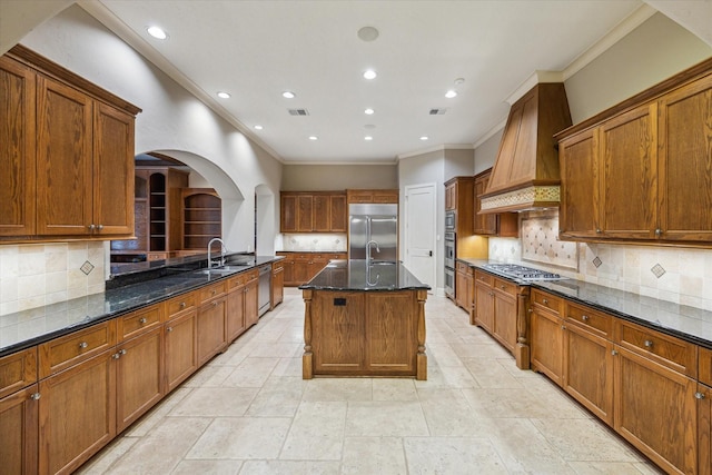 3110 Noble Lakes Ln, Houston, TX 77082 - kitchen featuring stainless steel appliances, ornamental molding, custom exhaust hood, a sink, and dark stone countertops