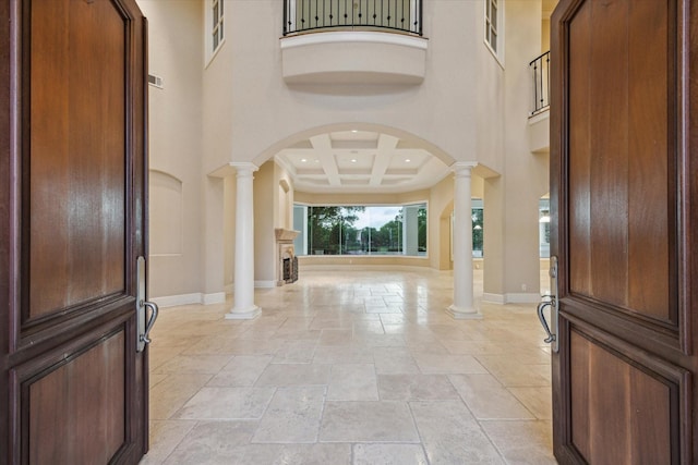 3110 Noble Lakes Ln, Houston, TX 77082 - entrance foyer with decorative columns, arched walkways, stone tile floors, a towering ceiling, and baseboards