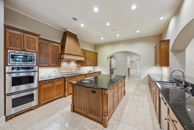 3110 Noble Lakes Ln, Houston, TX 77082 - kitchen with appliances with stainless steel finishes, arched walkways, premium range hood, crown molding, and a sink