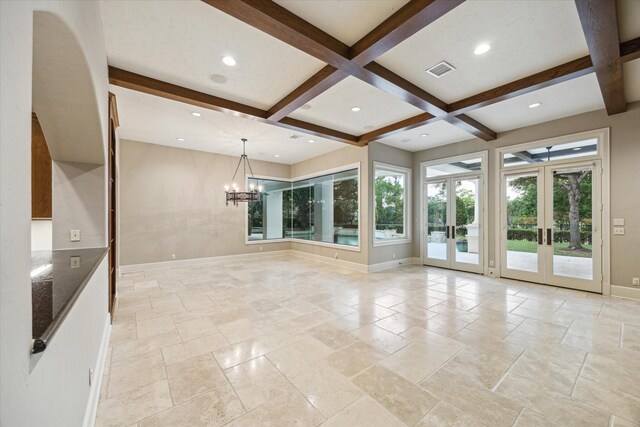 3110 Noble Lakes Ln, Houston, TX 77082 - unfurnished living room featuring french doors, baseboards, beamed ceiling, stone tile flooring, and a chandelier