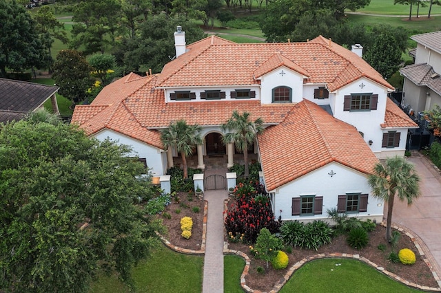 3110 Noble Lakes Ln, Houston, TX 77082 - mediterranean / spanish house with a chimney, a tiled roof, stucco siding, and a front lawn